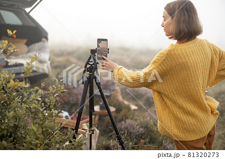 Woman traveler shooting on phone her picnic while travel Woman traveler shooting on phone her picnic while travel 81320273