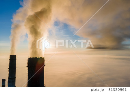 Aerial view of coal power plant high pipes with black smoke moving up polluting atmosphere at sunset. Aerial view of coal power plant high pipes with black smoke moving up polluting atmosphere at sunset. 81320961