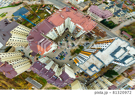 Aerial view of parked cars on parking lot between high apartment buildings. Aerial view of parked cars on parking lot between high apartment buildings. 81320972