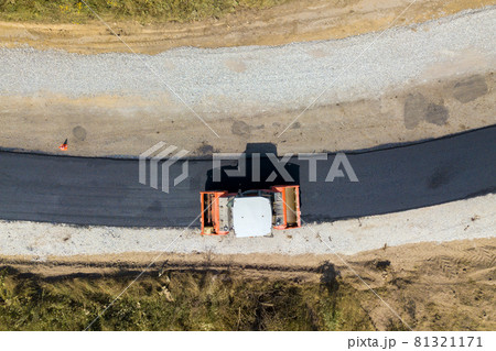 Aerial view of new road construction with steam roller machine at work. 81321171