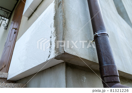 Installation of styrofoam insulation sheets on house facade wall for thermal protection. Installation of styrofoam insulation sheets on house facade wall for thermal protection. 81321226
