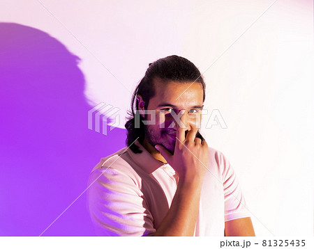 young model posing in a studio in a trendy neon light. young model posing in a studio in a trendy neon light. 81325435