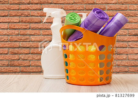 Bottle of dishwashing liquid, basket with garbage bags and sponges. Bottle of dishwashing liquid, basket with garbage bags and sponges. 81327699