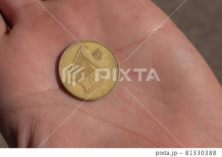 Modern Israeli coin in the hand. 0,5 sheqel 81330388