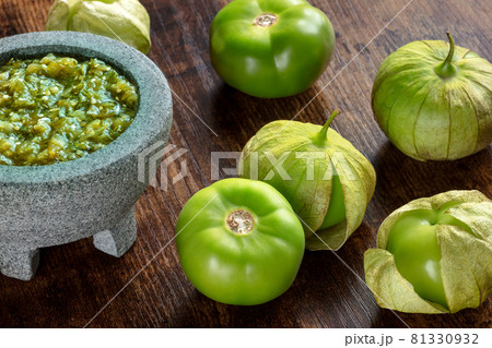 Tomatillos, green tomatoes, with salsa verde, green sauce, in a molcajete 81330932