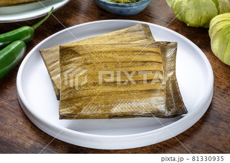 Tamales, traditional dish of the cuisine of Mexico, on a wooden background 81330935