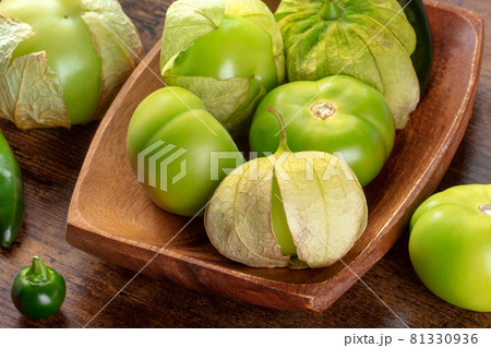 Tomatillos, green tomatoes, Mexican cuisine ingredient on a wooden background Tomatillos, green tomatoes, Mexican cuisine ingredient on a wooden background 81330936
