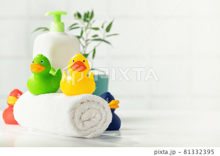 Bathroom accessories on white bathroom countertop against tile wall 81332395