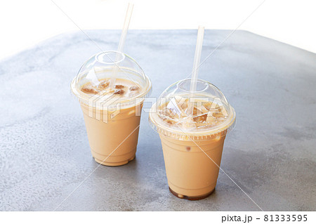 Iced coffee or latte in take away plastic cup on street cafe stone table Iced coffee or latte in take away plastic cup on street cafe stone table 81333595