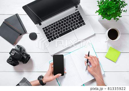 Overhead view of businesswoman working at computer in office Overhead view of businesswoman working at computer in office 81335922