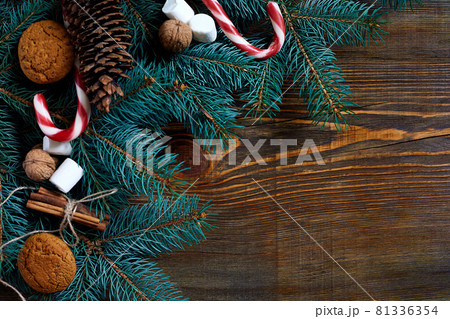 Christmas or New Year background with cookies, spices, cinnamon, nuts and fir tree branch on dark wooden background. 81336354