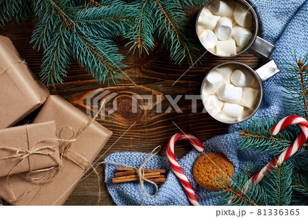 Christmas drink. Mug hot coffee with marshmallow, red candy cane on the wooden background. New Year. 81336365