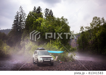 Car camping at mountain river 81341583