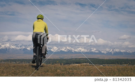The man travel on mixed terrain cycle touring with bikepacking. The traveler journey with bicycle bags. Sport tourism bikepacking. 81342035
