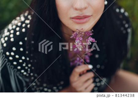Young brunette woman on blooming Sally flower field. Lilac flowers and girl. Young brunette woman on blooming Sally flower field. Lilac flowers and girl. 81344238