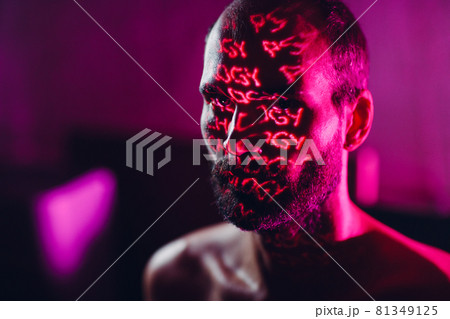 Young adult man with word Psychology on his face in the dark. Young adult man with word Psychology on his face in the dark. 81349125