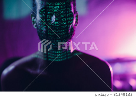 Young adult man with word Psychology on his face in the dark. Young adult man with word Psychology on his face in the dark. 81349132