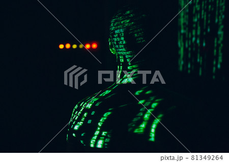 Young man with geen abstract letters on his face in the dark. Young man with geen abstract letters on his face in the dark. 81349264