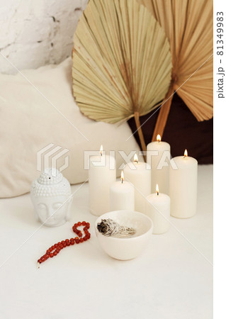 Meditation place with candles and smudge stick in yoga studio Meditation place with candles and smudge stick in yoga studio 81349983
