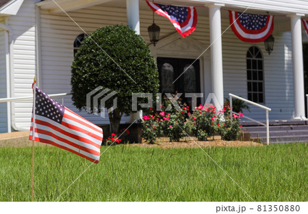 American Flag With Small Rural Church in Background Shallow DOF Focus on Flag 81350880
