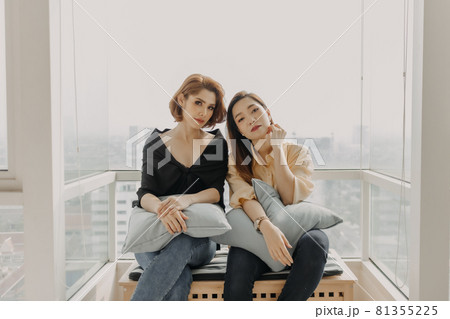 Cool looking women friends having photoshoot in their apartment. Cool looking women friends having photoshoot in their apartment. 81355225