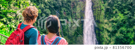 Hawaii travel tourists at nature waterfall panoramic landscape banner. Travelers couple looking at Akaka Falls in Big Island, Hawaiian famous attraction, USA 81356700