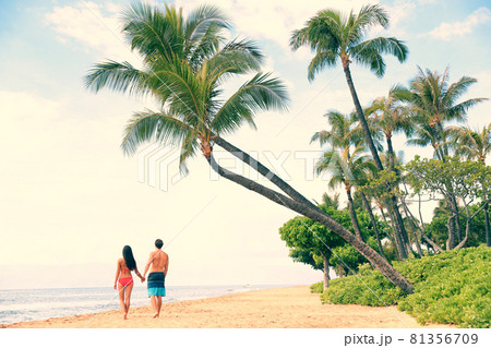 Hawaii beach travel holidays people relaxing on sunset tropical vacation couple walking. Kaanapali beach, Maui, Hawaii, USA. Man, woman together on famous hawaiian beach summer destination Hawaii beach travel holidays people relaxing on sunset tropical vacation couple walking. Kaanapali beach, Maui, Hawaii, USA. Man, woman together on famous hawaiian beach summer destination 81356709