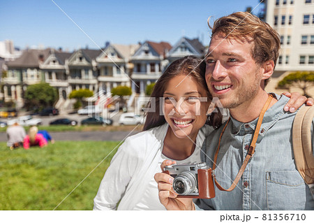 San Francisco Painted Ladies houses people tourists on America summer trip holidays taking photos, Young multiethnic couple asian woman, caucasian man 81356710