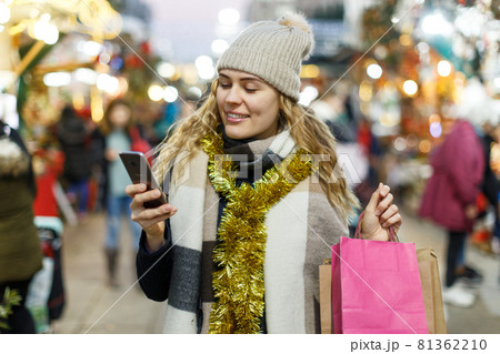 Woman making picture at Christmas fair Woman making picture at Christmas fair 81362210