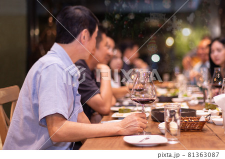 Holiday celebration concept friends having christmas dinner party and drinking red wine at home. 81363087