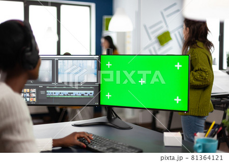 African woman multimedia content creator with headphones processing film montage African woman multimedia content creator with headphones processing film montage 81364121