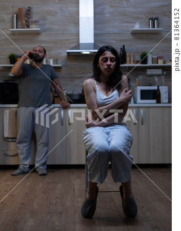 Abused bruised woman being terrified of violent man Abused bruised woman being terrified of violent man 81364152