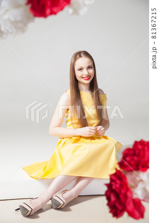 Portrait of smiling model in yellow dress with red lips Portrait of smiling model in yellow dress with red lips 81367215