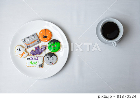 hot coffee cup with funny Halloween Cookies. Happy Halloween day, Trick or Threat, Hello October, fall autumn, Traditional, party and holiday concept hot coffee cup with funny Halloween Cookies. Happy Halloween day, Trick or Threat, Hello October, fall autumn, Traditional, party and holiday concept 81370524