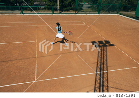 Top view of tennis sportswoman playing tennis on outside court in summer day Top view of tennis sportswoman playing tennis on outside court in summer day 81371291
