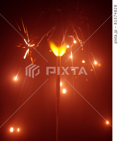 Christmas sparkler in haze with red light 81374828