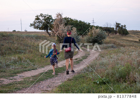 Mother and daughner running back view. Happy family concept. 81377848