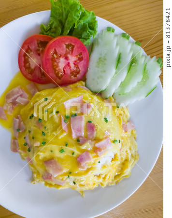 Jasmine rice with ham soft omelet served with the tomato and cucumber sliders. Jasmine rice with ham soft omelet served with the tomato and cucumber sliders. 81378421