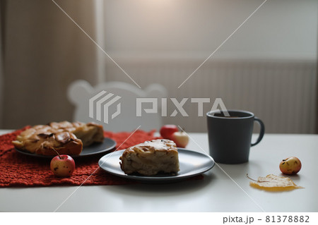 Breakfast with homemade apple pie and a cup of coffee on white table in a sunny morning 81378882