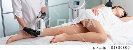 cosmetologist in rubber gloves doing endospheres therapy on female legs cosmetologist in rubber gloves doing endospheres therapy on female legs 81380300