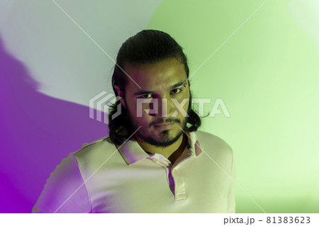 gay man with colored lights looking at camera 81383623