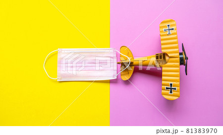 Airplane and medical mask on pastel background. Travel new normal and safety life. Airplane and medical mask on pastel background. Travel new normal and safety life. 81383970