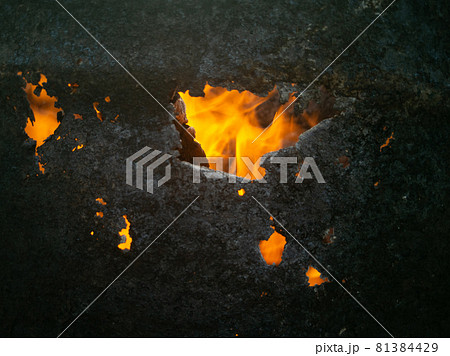 building on fire close up. fiery fires. bright fire through a burnt hole. fires concept building on fire close up. fiery fires. bright fire through a burnt hole. fires concept 81384429