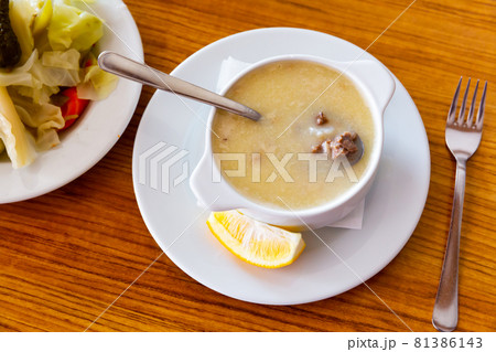 Turkish soup Paca corbasi served with pickle vegetables 81386143
