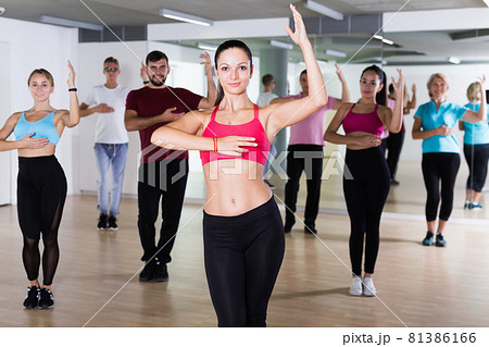People training dance together in fitness studio People training dance together in fitness studio 81386166