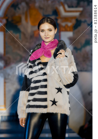 Fashion model walks on runway in fur coat Fashion model walks on runway in fur coat 81388614