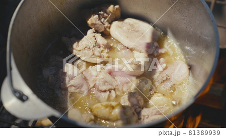 Meat is fried in a pot over an open fire on a camping trip, outdoor recreation with cooking, food on the fire on a day off, a traditional dish with meat, cuisine in extreme conditions Meat is fried in a pot over an open fire on a camping trip, outdoor recreation with cooking, food on the fire on a day off, a traditional dish with meat, cuisine in extreme conditions 81389939