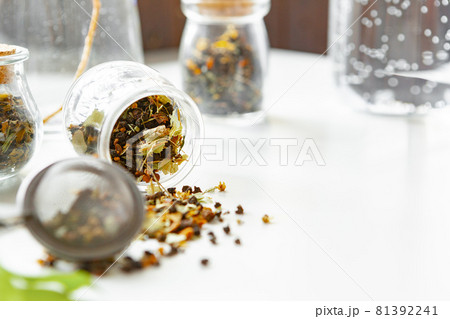 Glass jars with dry tea leaves close up on white table Glass jars with dry tea leaves close up on white table 81392241