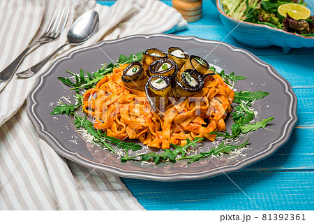 Pasta with eggplants, tomato, cheese and arugula 81392361