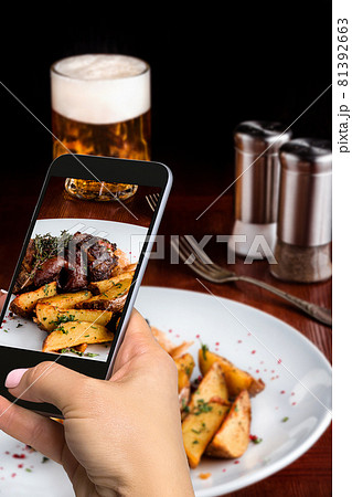 A young woman taking photo of food on smartphone, photographing meal with mobile camera A young woman taking photo of food on smartphone, photographing meal with mobile camera 81392663